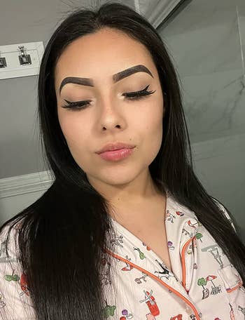 same reviewer showing off winged liner with eyes closed