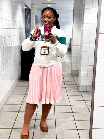 Reviewer in a pleated pink skirt