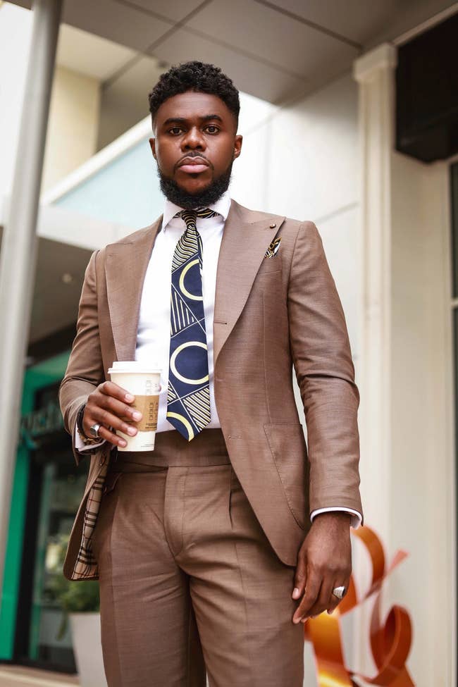 model wearing burberry suit with blue and yellow print tie