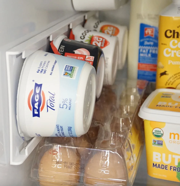 the yogurt rack mounted on the side of a fridge