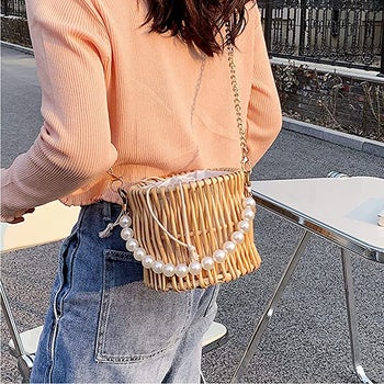 the same model wearing the bag as a crossbody
