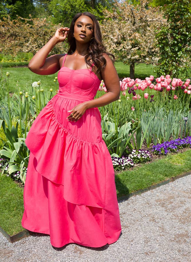 model in spaghetti strap hot pink maxi with sweetheart neckline and large ruffle on skirt