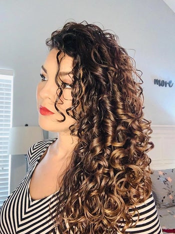 image of reviewer with healthy and shiny curly hair