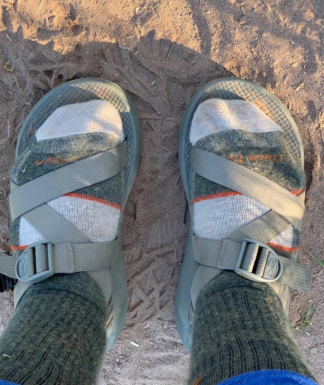 reviewer wearing the camping socks with chacos