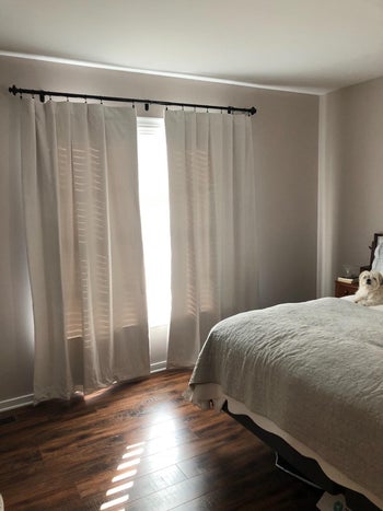 porcelain white curtains hung over a door, with some light filtering through