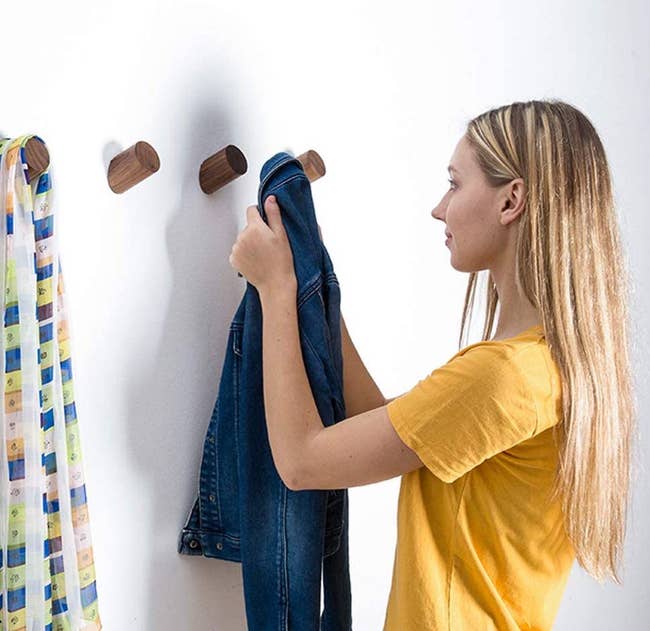 model hanging items on the small wooden peg wall hooks