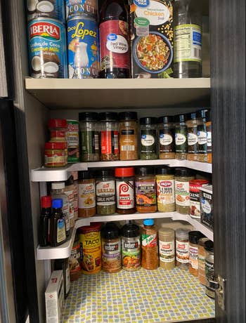 same reviewer's pic of space rack that has three tiers and hugs the shape of the kitchen cabinet