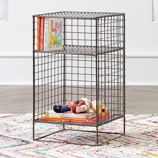 black wire nightstand with kids' toys and books inside