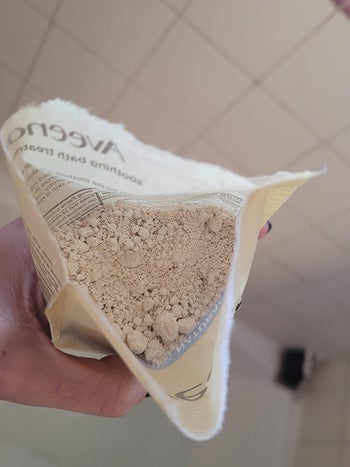 an open packet filled with a fine ground cream powder