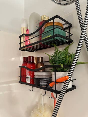 another reviewer photo of matte black shelves holding bottles in the shower