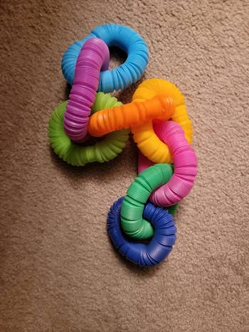 Interlocking, textured fidget rings successful  assorted  colors, placed connected  a carpet, perfect  for sensory play   oregon  accent   relief