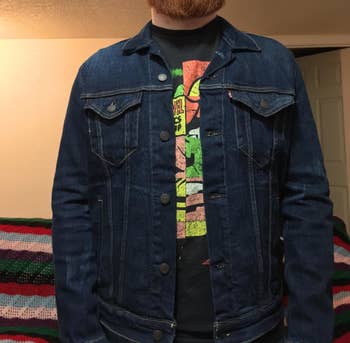 same reviewer wearing denim jacket unbuttoned with a graphic tee underneath
