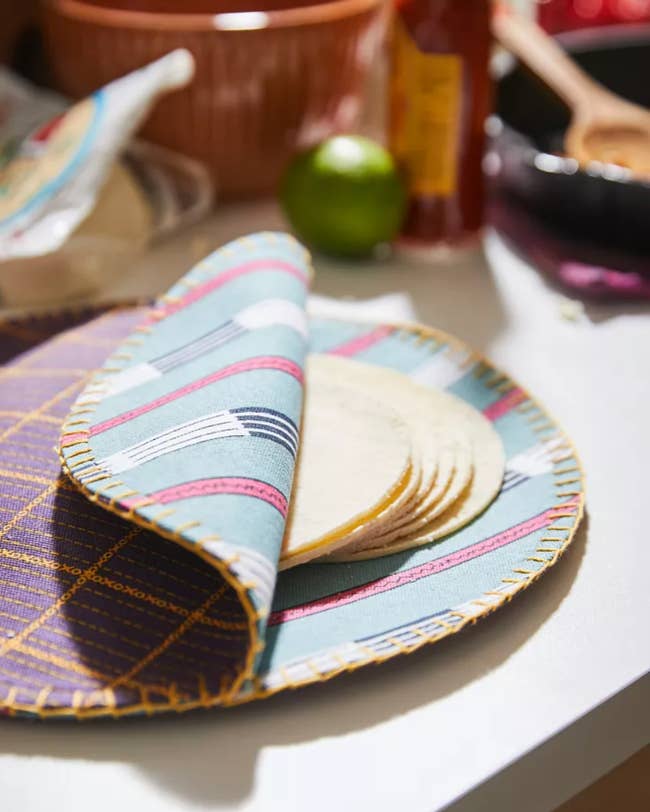 the circular fabric pocket with stitched edges and tortillas in the inside