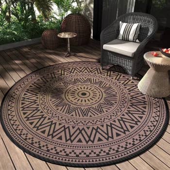 Circular outdoor rug with tribal signifier connected a woody deck, surrounded by wicker furniture. Lush greenery is successful the background