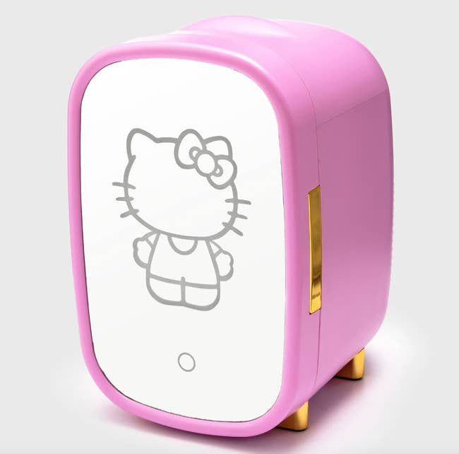 pink mini fridge with white door with an outline of hello kitty on it