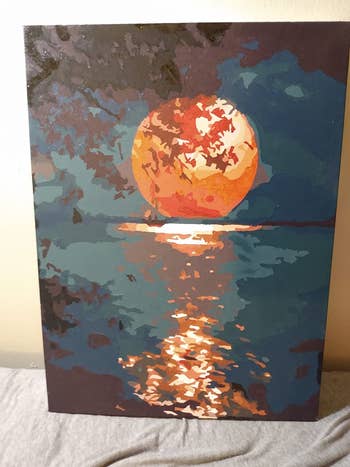 reviewer painting of the moon reflecting light on water