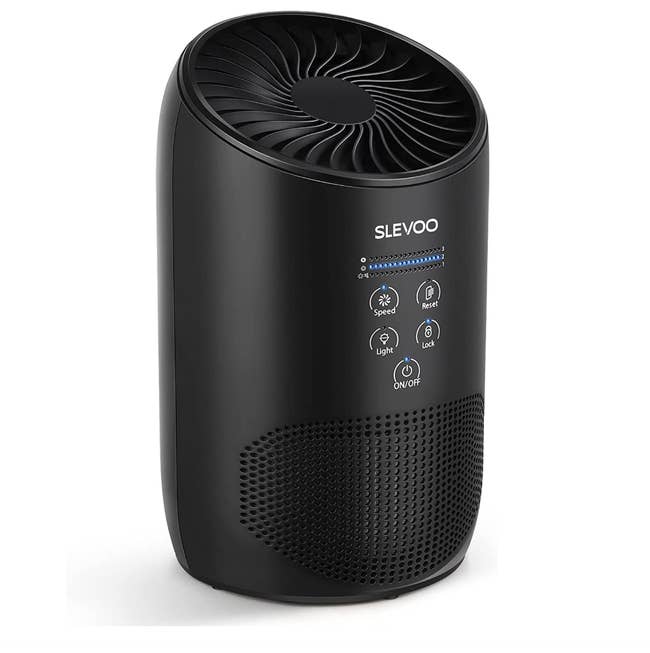 Black small air purifier with five button settings on a white background