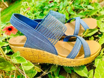 A brace  of wedge sandals with bluish  straps