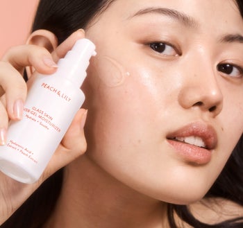 model applying clear gel moisturizer on face
