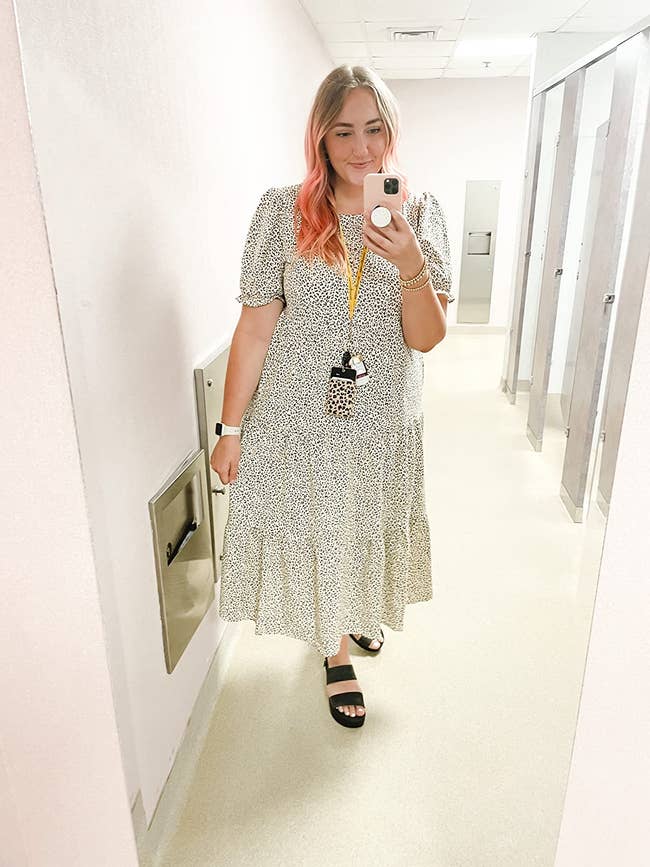 reviewer wearing the apricot dress leopard-print dress with black chunky sandals