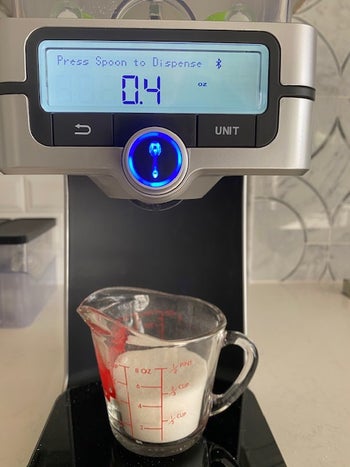 reviewers digital scale with measuring cup underneath
