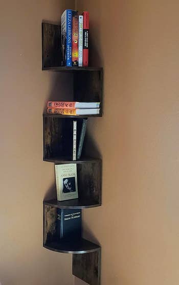 Reviewer image of dark brown zig-zag corner bookshelf with books on display