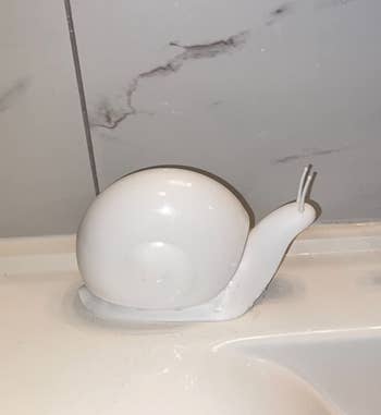 a reviewer photo of the snail soap pump in white 