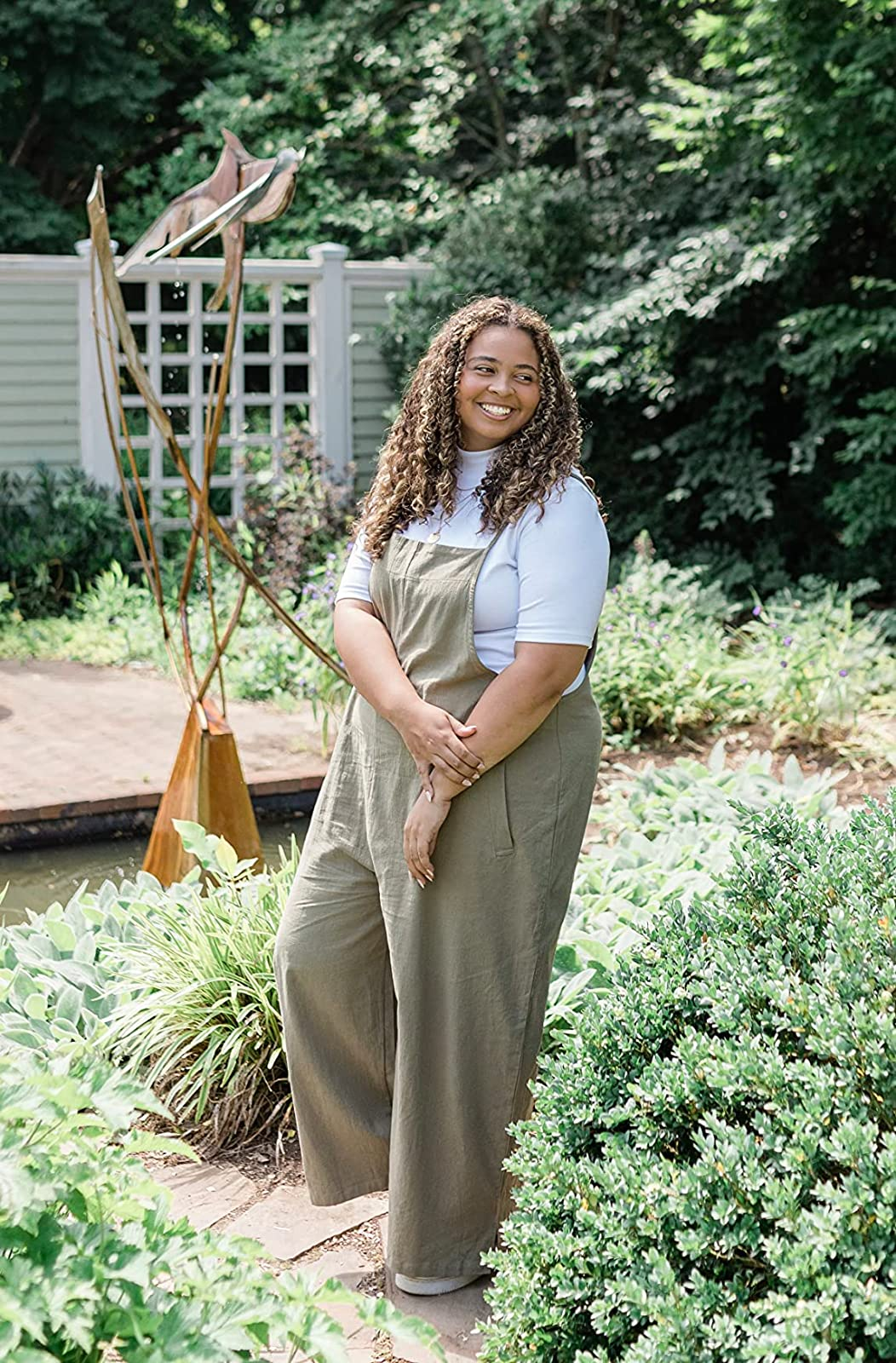 reviewer wearing the green jumpsuit over a white shirt