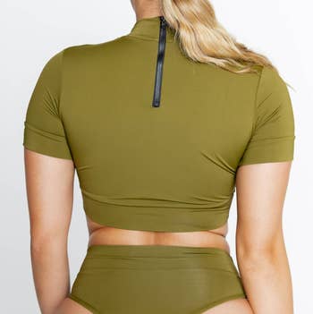 model showing the back of the moss crop top from Momma, displaying a zipper
