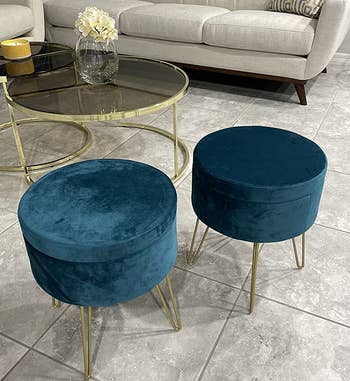 reviewer image of two teal storage ottomans in a living room