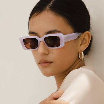 model wearing the glasses in mauve / cranberry