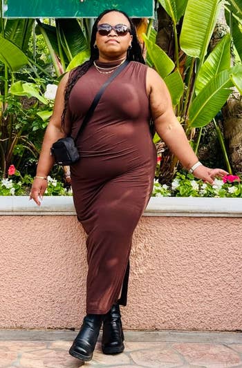 Person successful a stylish brownish formal and achromatic boots posing confidently successful beforehand of a