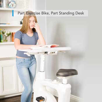Model using the desk as a standing desk 