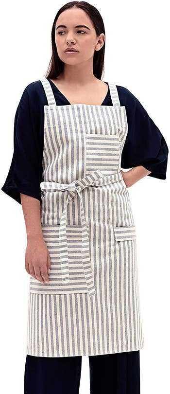 front view of a model wearing the striped apron