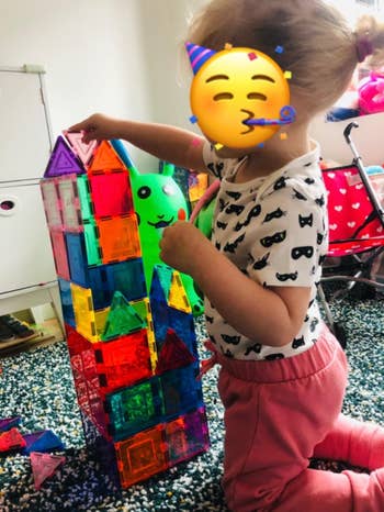 another reviewer photo of a toddler building a house with the tiles