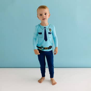 a child in a two piece police officer pajama set