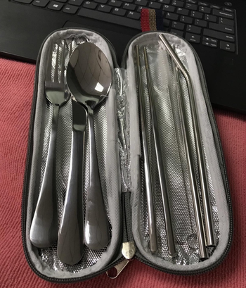 a reviewer photo of the open case filled with the cutlery set