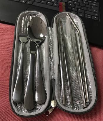 a reviewer photo of the open case filled with the cutlery set 
