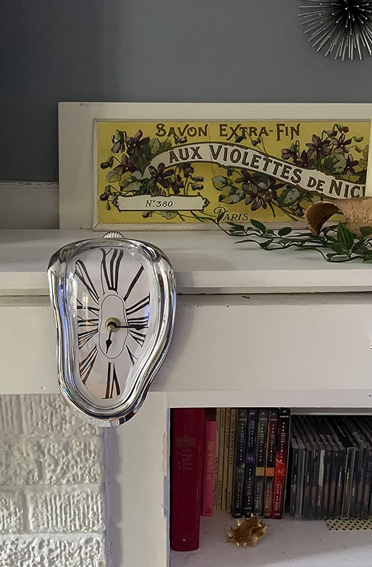 clock on reviewer's book shelf hanging off