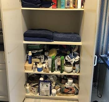 Bathroom furniture filled with toiletries, towels, and assorted idiosyncratic attraction products organized connected shelves