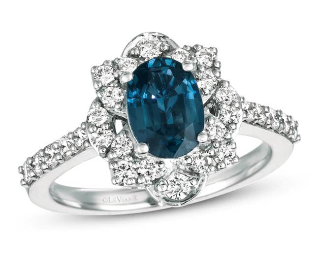 The sapphire stone surrounding by diamonds that go down the silver band as well