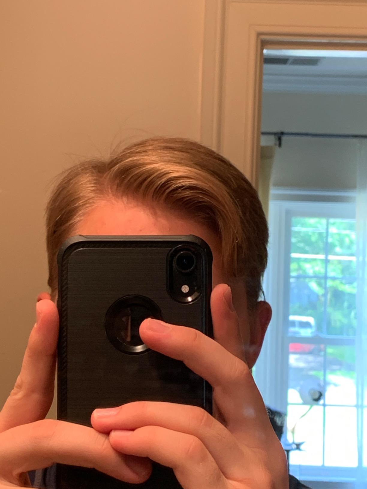 reviewer with hair perfectly in place thanks to the product