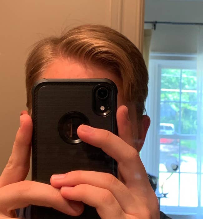 reviewer with hair perfectly in place thanks to the product