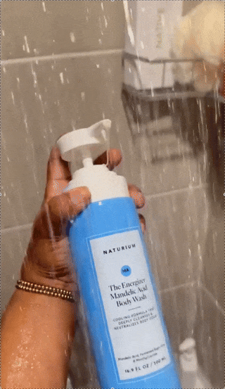Person utilizing Naturium The Energiere Mandelic Acid Body Wash successful  a shower