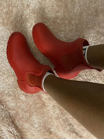a reviewer in red ugg ankle booties