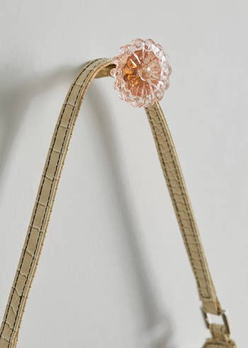 a floral-shaped hook with a bag hanging from it