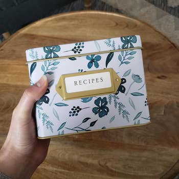 a reviewer holding the white and blue box