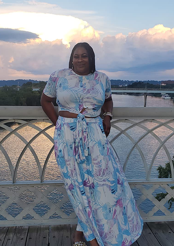 reviewer wearing the white, blue, and purple skirt set