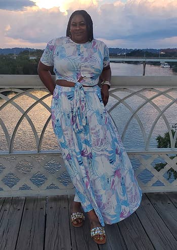 reviewer wearing the white, blue, and purple skirt set