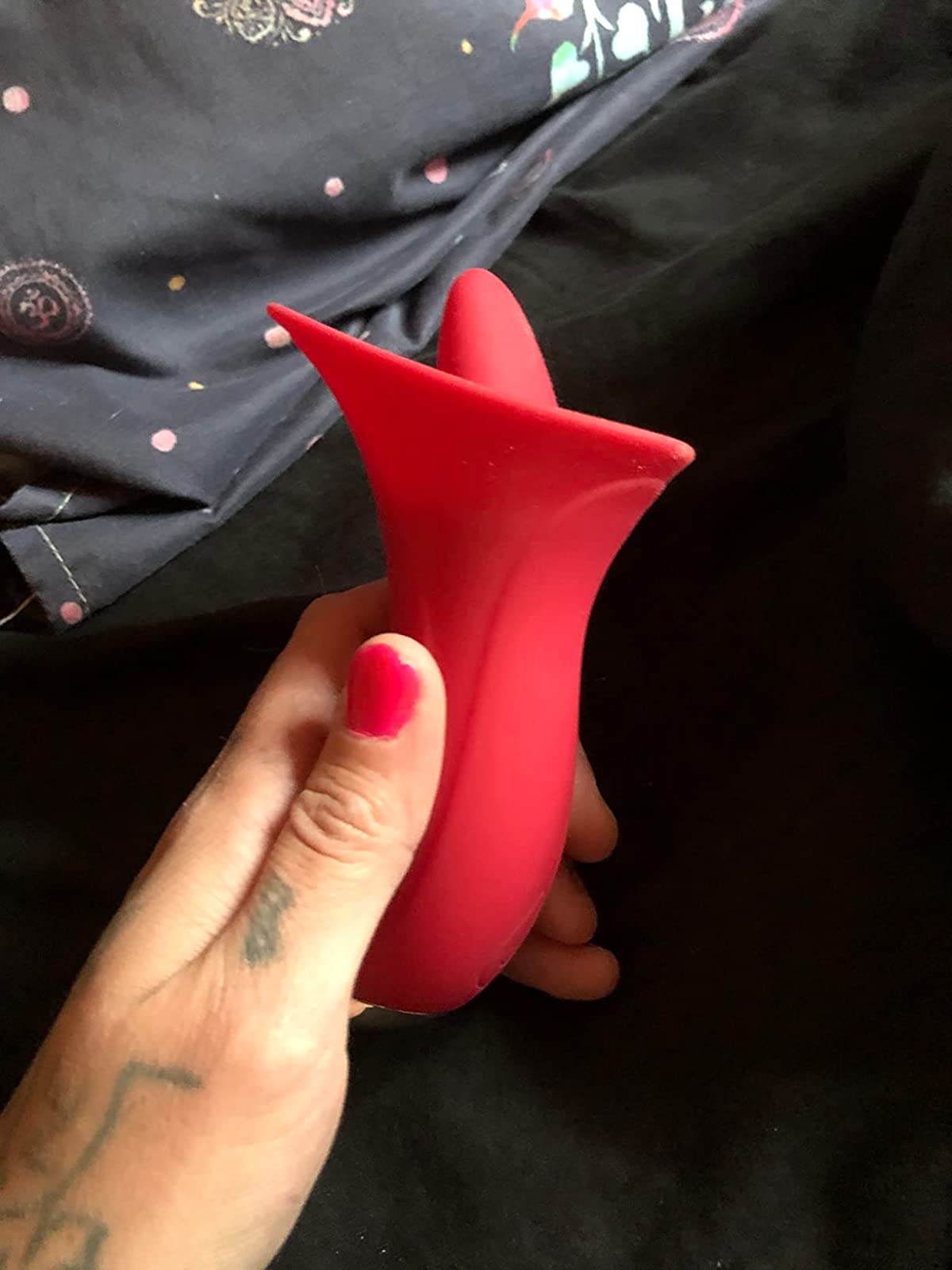 Reviewer holding red licking vibrator